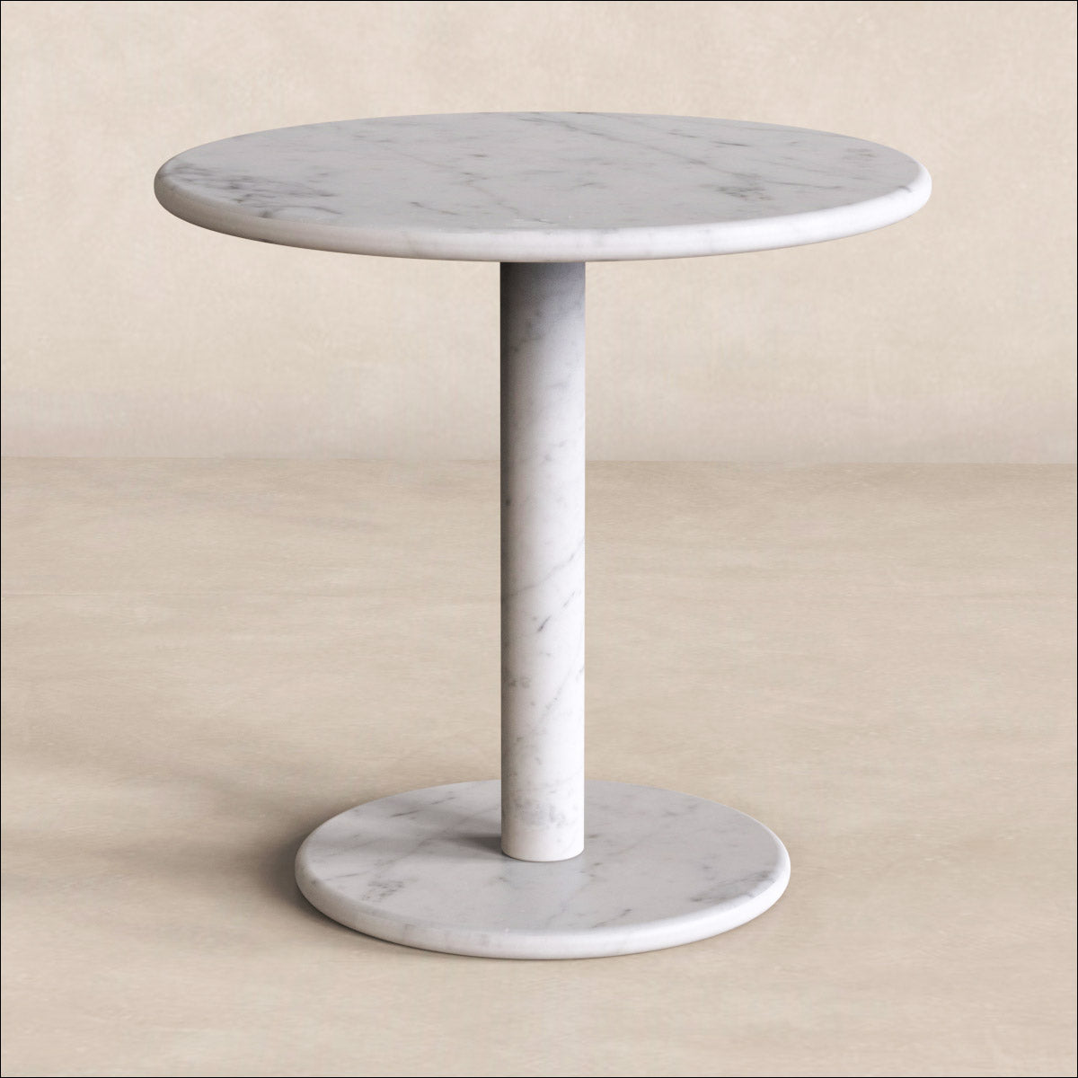RoundHaven white marble side table with a round top, slim cylindrical column and circular base against a neutral backdrop.