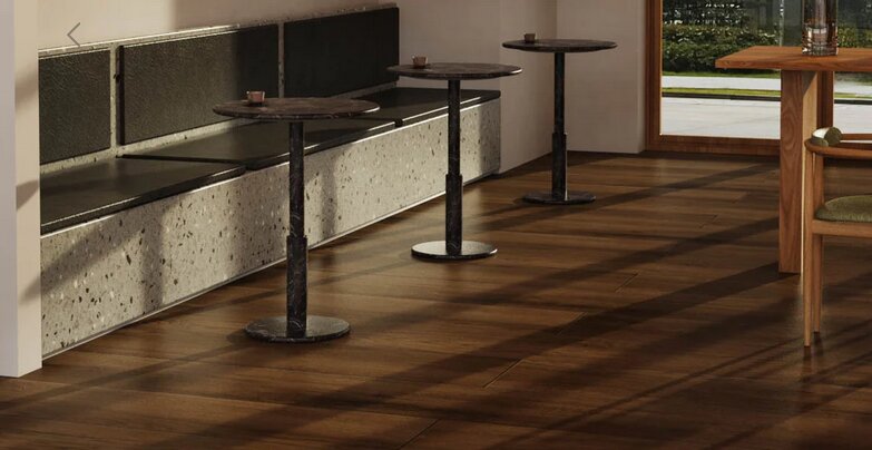 Marble and travertine bistro tables styled in a refined hospitality interior