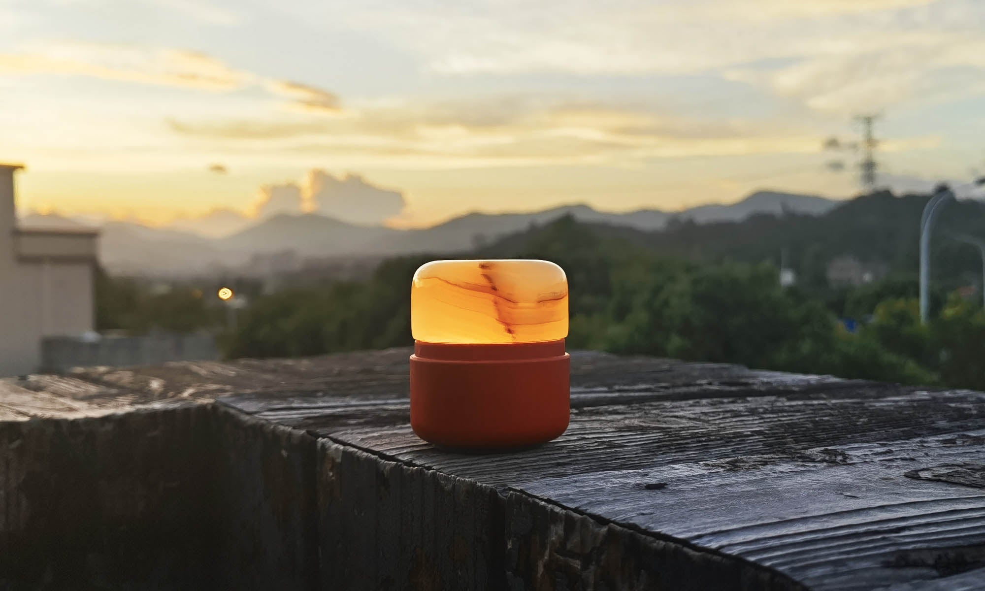Wireless onyx table lamp glowing softly in an outdoor setting