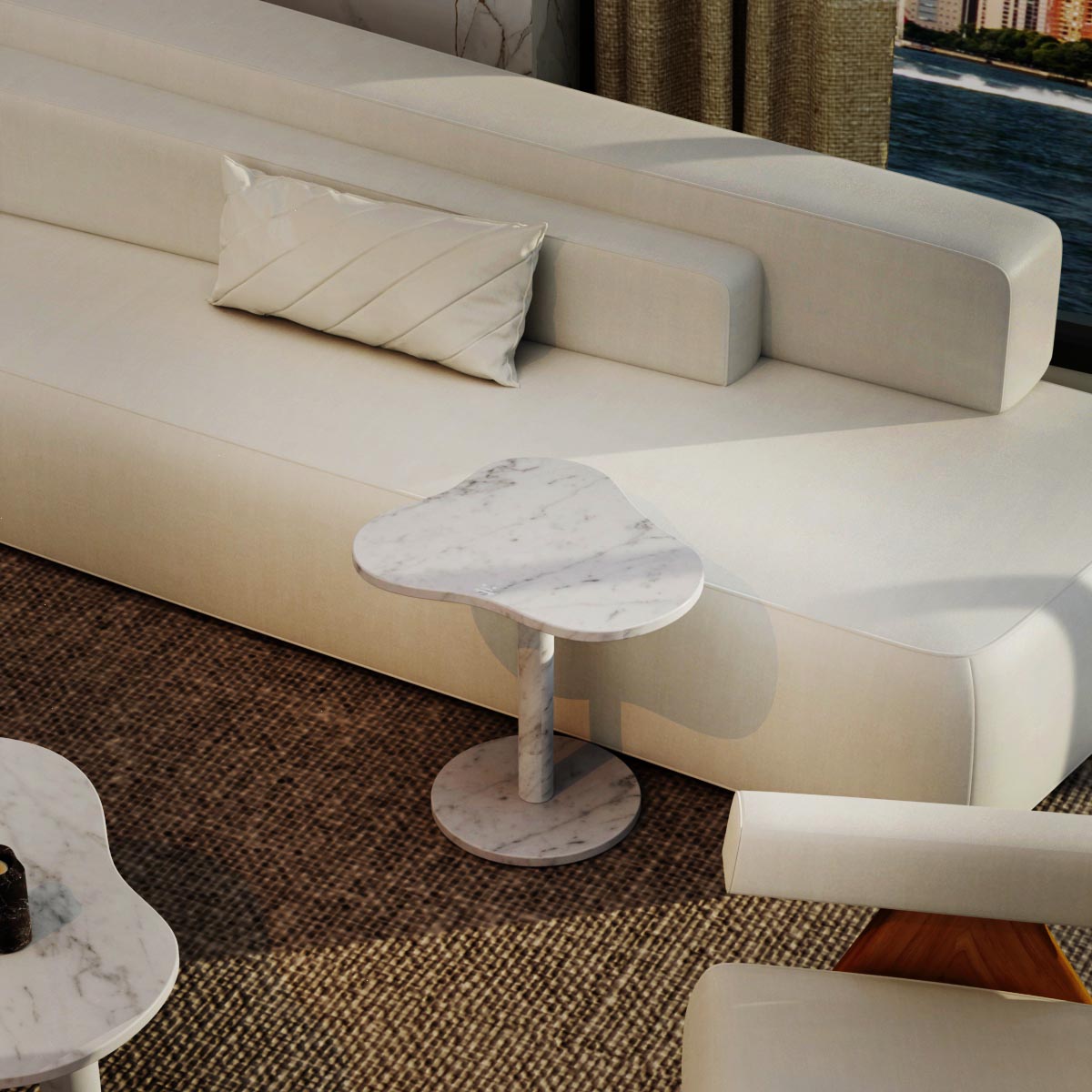 Carrara marble side table styled beside a white sofa in a modern living room