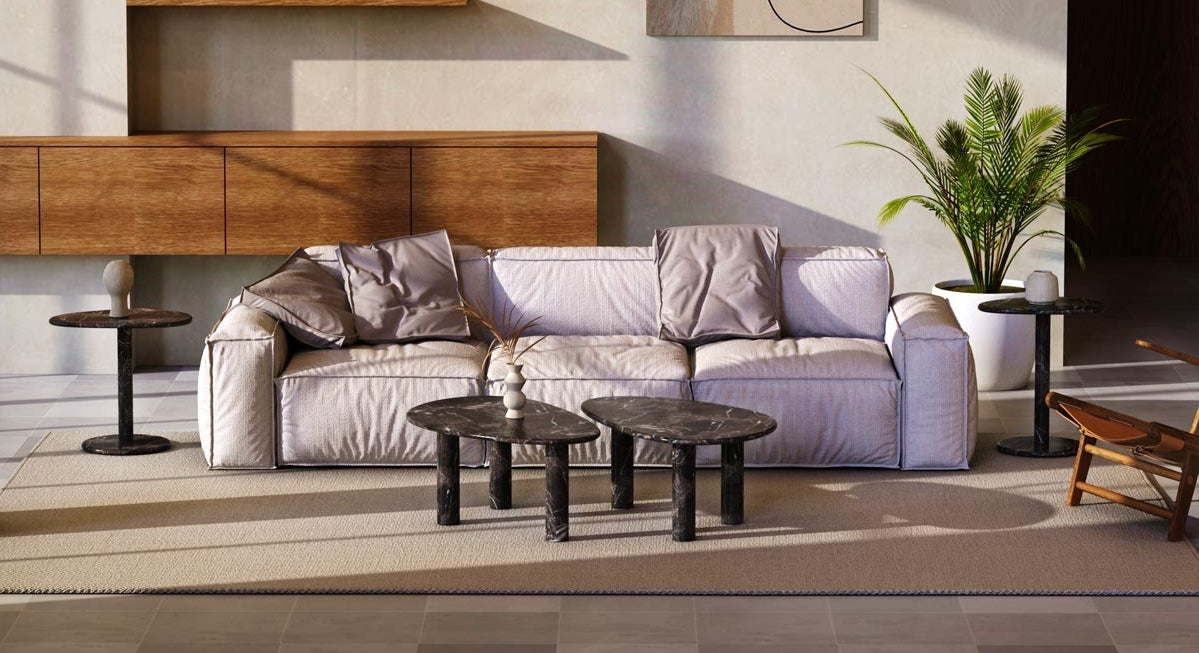 Oval marble and travertine tables styled in a refined modern living room
