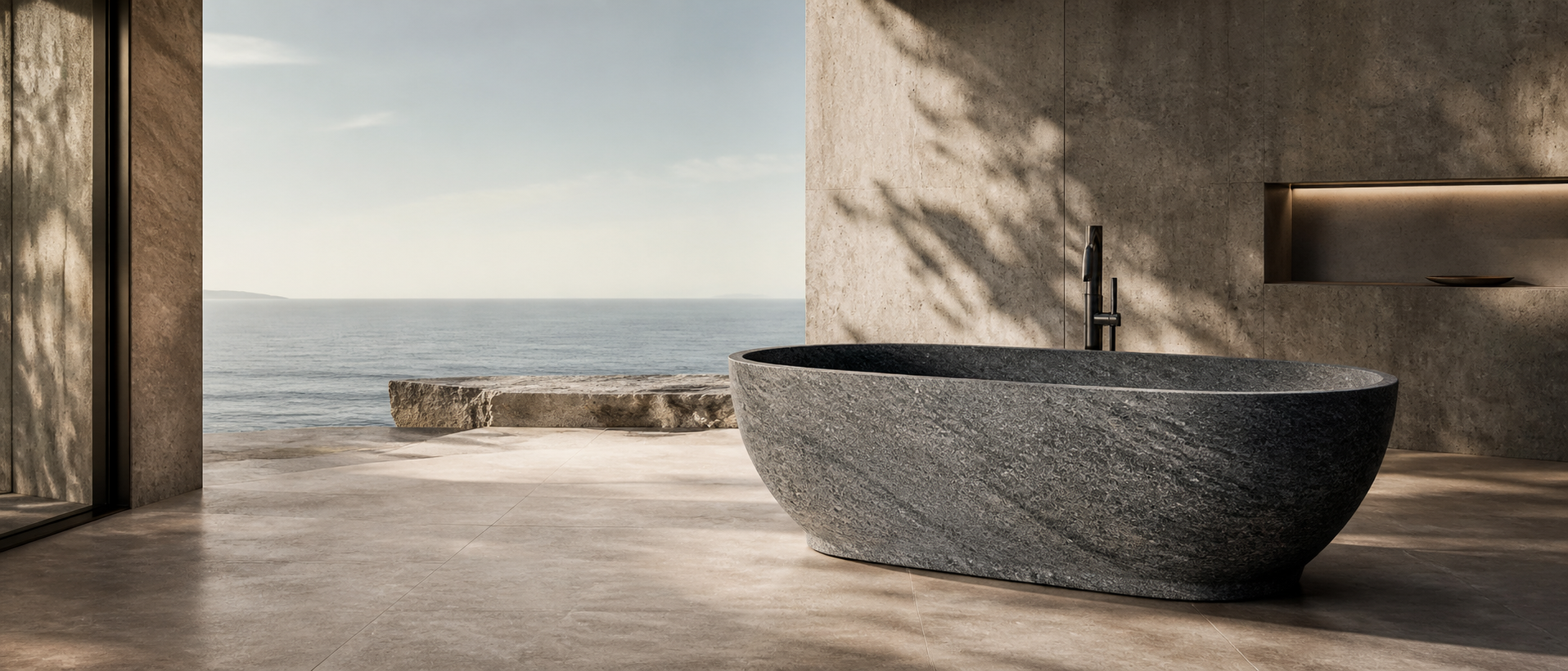 Freestanding granite bathtub in a natural outdoor bath setting