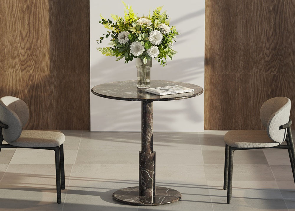 Round marble and travertine table styled in a refined modern interior