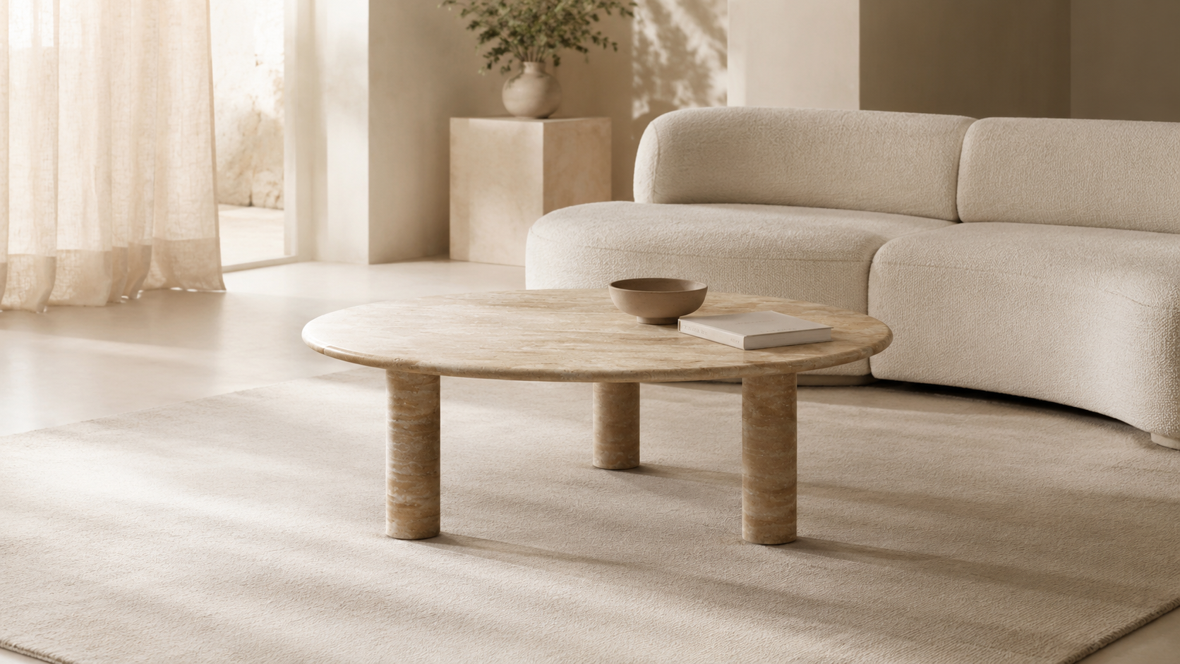 OIXDESIGN travertine coffee table styled in a calm modern living room with a cream sofa, soft natural light, and warm natural stone texture.