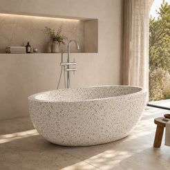 Aveline Alba White Terrazzo freestanding soaking bathtub in a warm sunlit luxury bathroom, hero scene