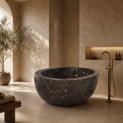 Aveline Dark Emperador Marble freestanding soaking bathtub in a warm luxury bathroom, hero scene