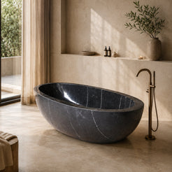 Aveline Portoro Black Marble freestanding soaking bathtub in a warm luxury bathroom, hero scene
