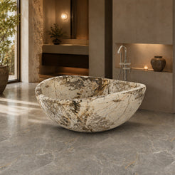 Lunara Pandora Blanc Quartzite round freestanding soaking bathtub in a warm luxury spa bathroom, hero scene