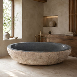 Yitta Filetto Cobble Stone Granite soaking bathtub in a warm architectural luxury bathroom, styled visualization