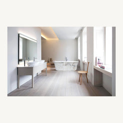 Elara Ivory Cloud Marble rolled-rim bathtub in a bright modern bathroom styled visualization