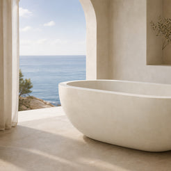 Serena Dune Ivory Limestone soaking bathtub in a coastal bathroom, styled visualization