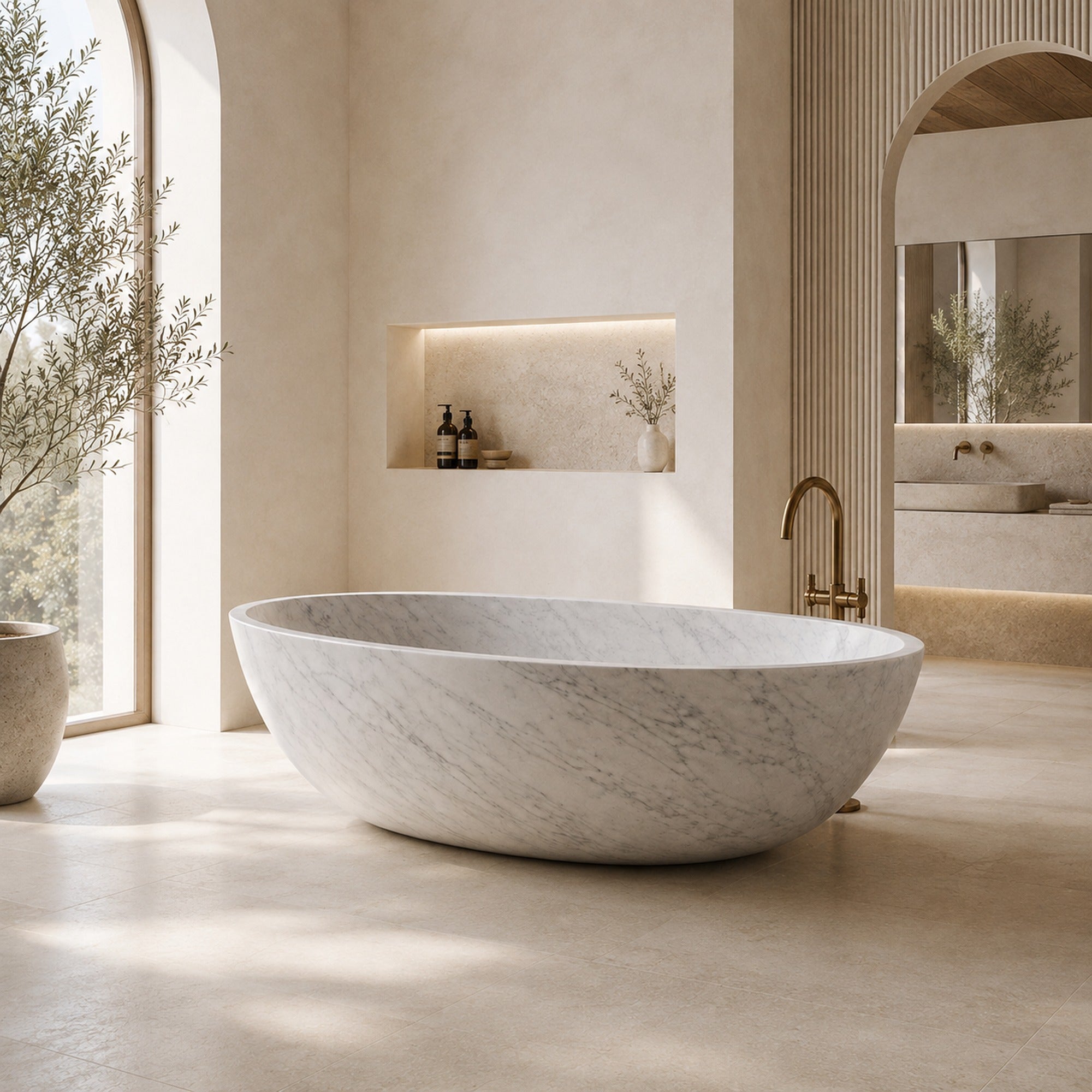Yaris Carrara White Marble freestanding soaking bathtub in a bright architectural luxury bathroom