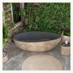 Yitta Filetto Cobble Stone Granite freestanding soaking bathtub in a styled bathroom setting