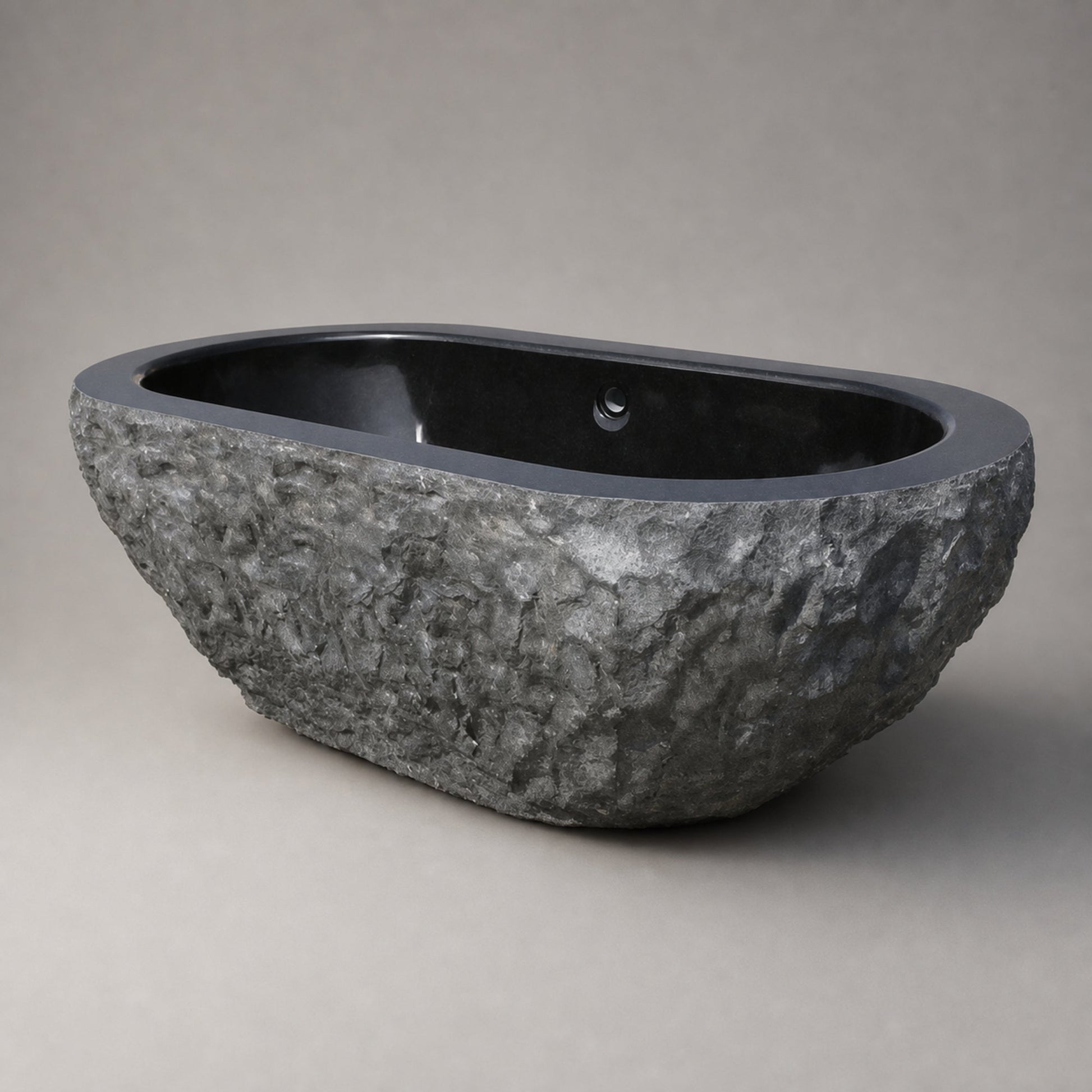 Arden Natural-Face Black Granite freestanding bathtub, three-quarter studio visualization