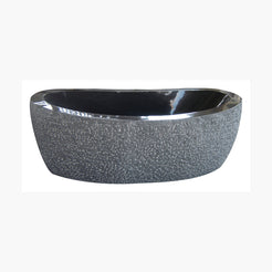 Calia Absolute Black Granite soaking bathtub with hand-chiseled exterior and polished interior, studio three-quarter visualization