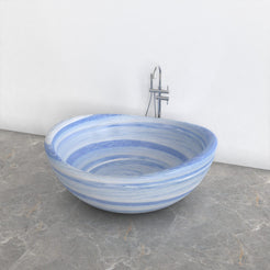 Lunara round freestanding Azura Blue Quartzite soaking bathtub, studio three-quarter view
