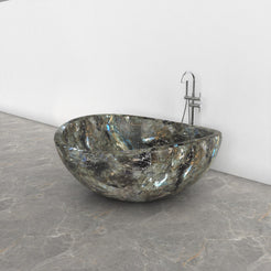 Lunara round freestanding Celestia Blue Quartzite soaking bathtub, studio three-quarter view