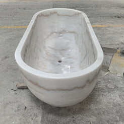 Actual Serena BT-105A Ivory Cloud Marble bathtub, real front and interior workshop view with centered drain