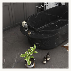 Yetta freestanding Portoro Black Marble bathtub, angled view with extended stone rim