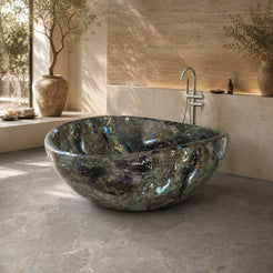 Lunara Celestia Blue Quartzite round freestanding soaking bathtub in a serene luxury bathroom with natural light, fourth lifestyle scene