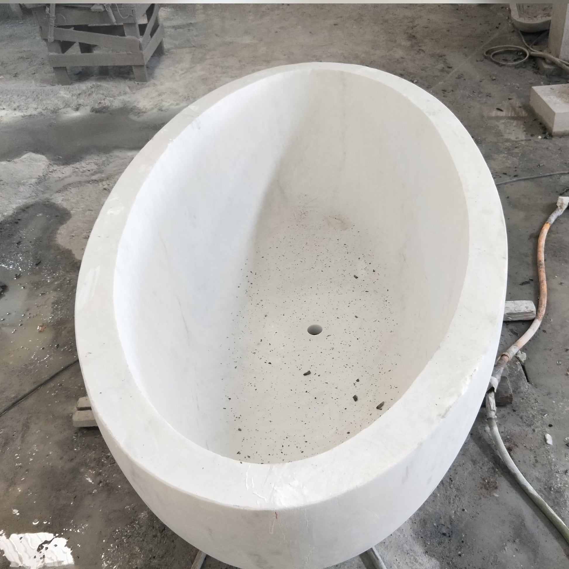 Actual Mira BT-031A Ivory Cloud Marble bathtub, real top and interior workshop view with centered drain