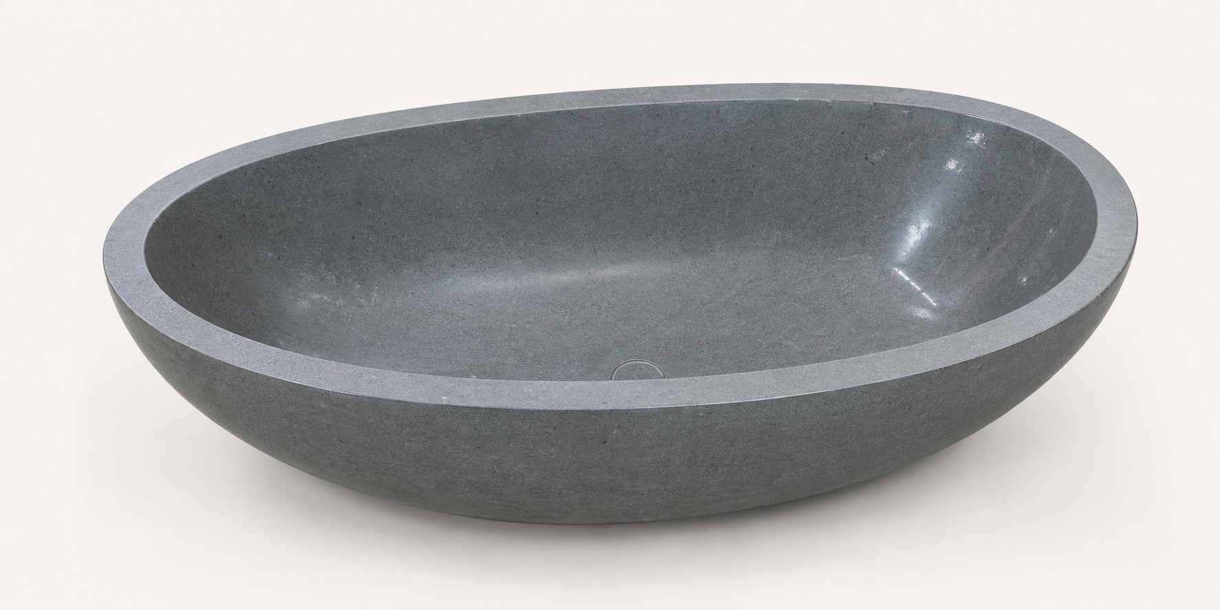 Nerida Blue-Gray Granite bathtub, elevated studio view of the oval interior and center drain