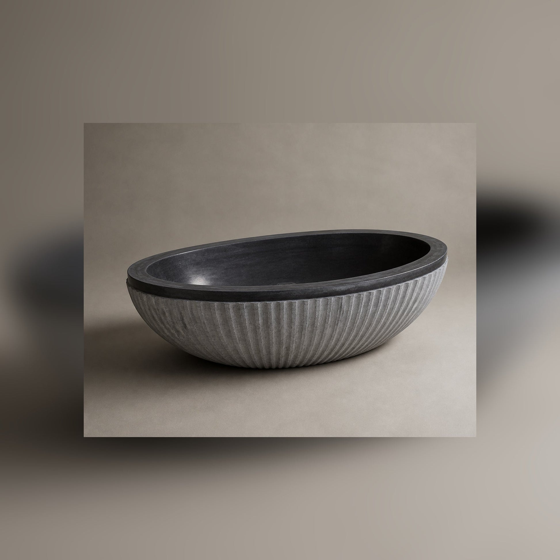 Rivelle fluted Midnight Black Granite freestanding bathtub, opposite-angle studio visualization