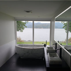 Actual installed Aurelia BT-038A Ivory Cloud Marble bathtub in a lake-view residential bathroom