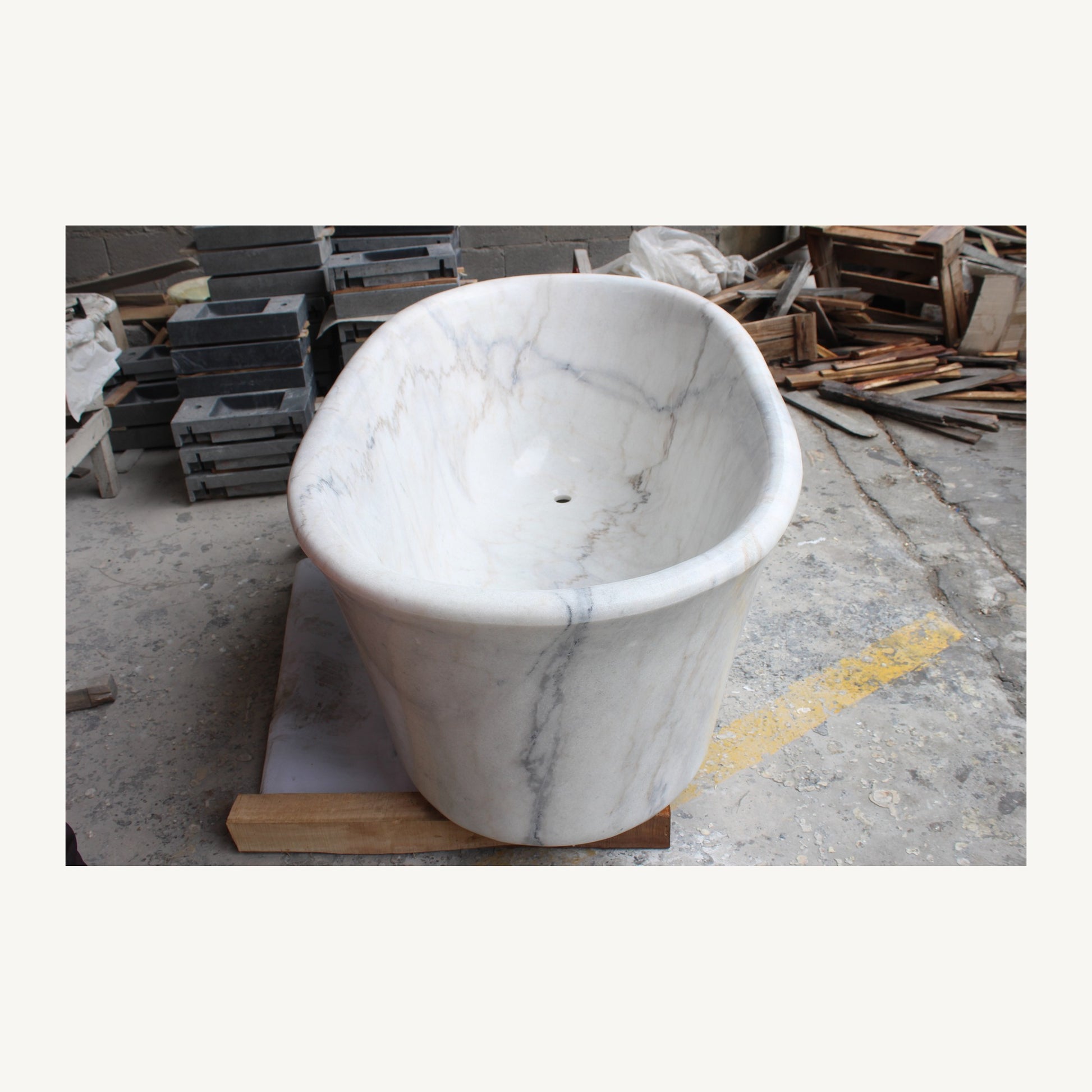 Actual Elara marble soaking bathtub, end and polished interior view at the stone workshop