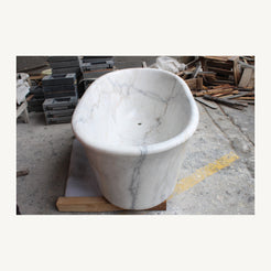 Actual Elara marble soaking bathtub, end and polished interior view at the stone workshop
