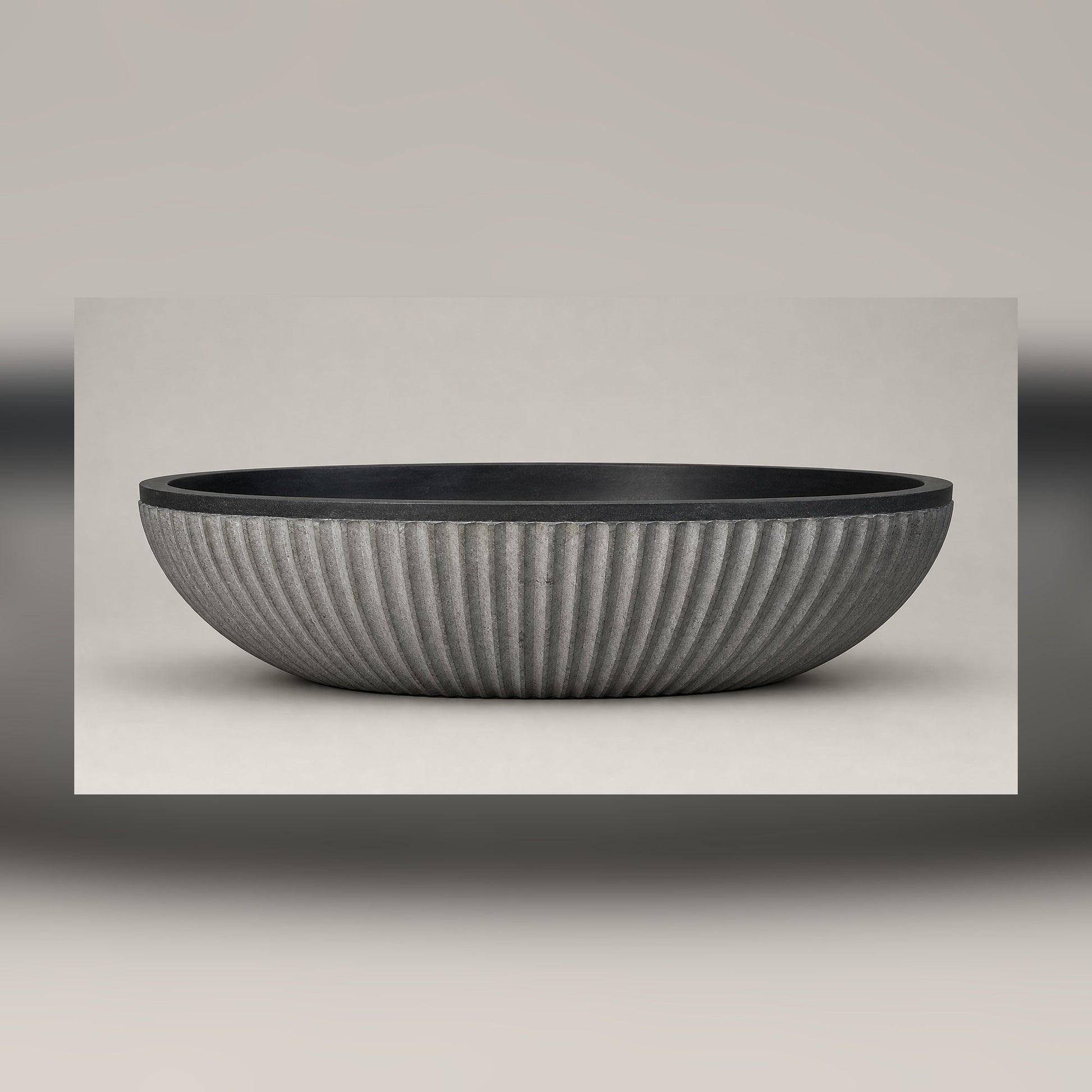 Rivelle fluted Midnight Black Granite bathtub, full side-profile studio visualization