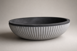 Rivelle freestanding fluted Natural Black Granite bathtub, premium studio angle