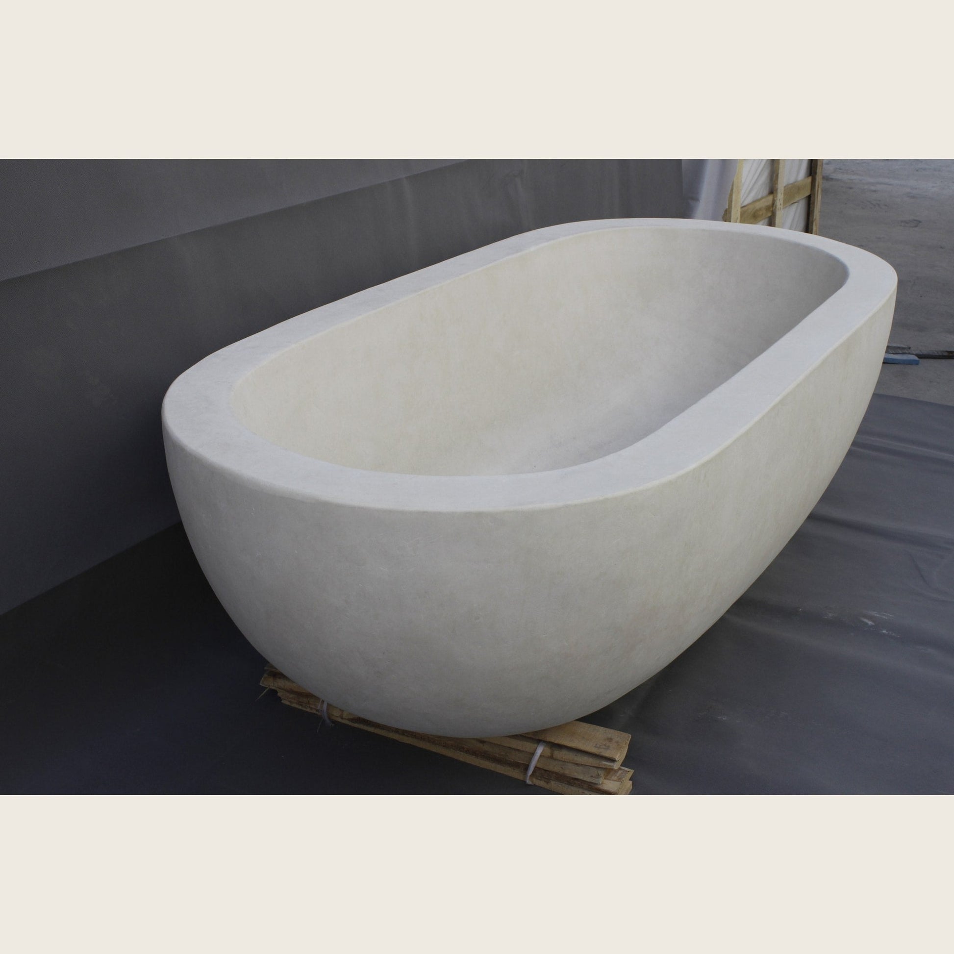Serena BT-105A Dune Ivory Limestone bathtub, real angled workshop view