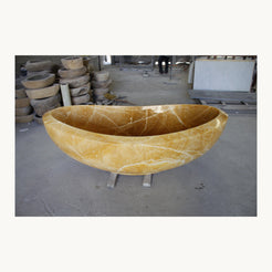 Real finished Yuna Honey Onyx bathtub photographed in the stone workshop