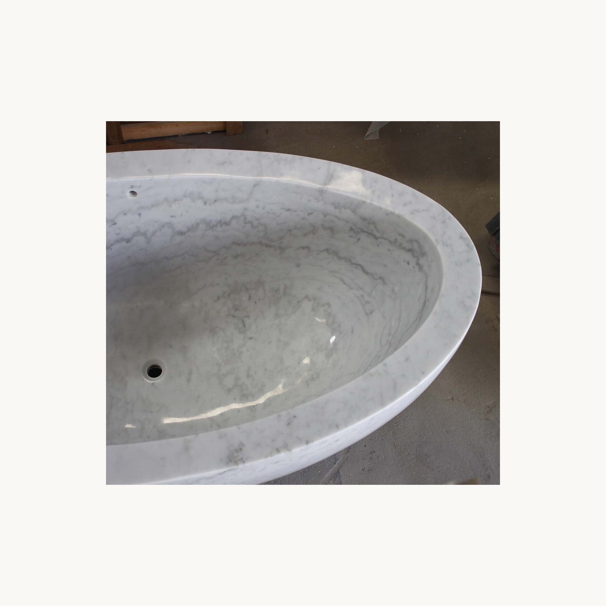Avela Ivory Cloud Marble bathtub, real polished interior and gray veining detail