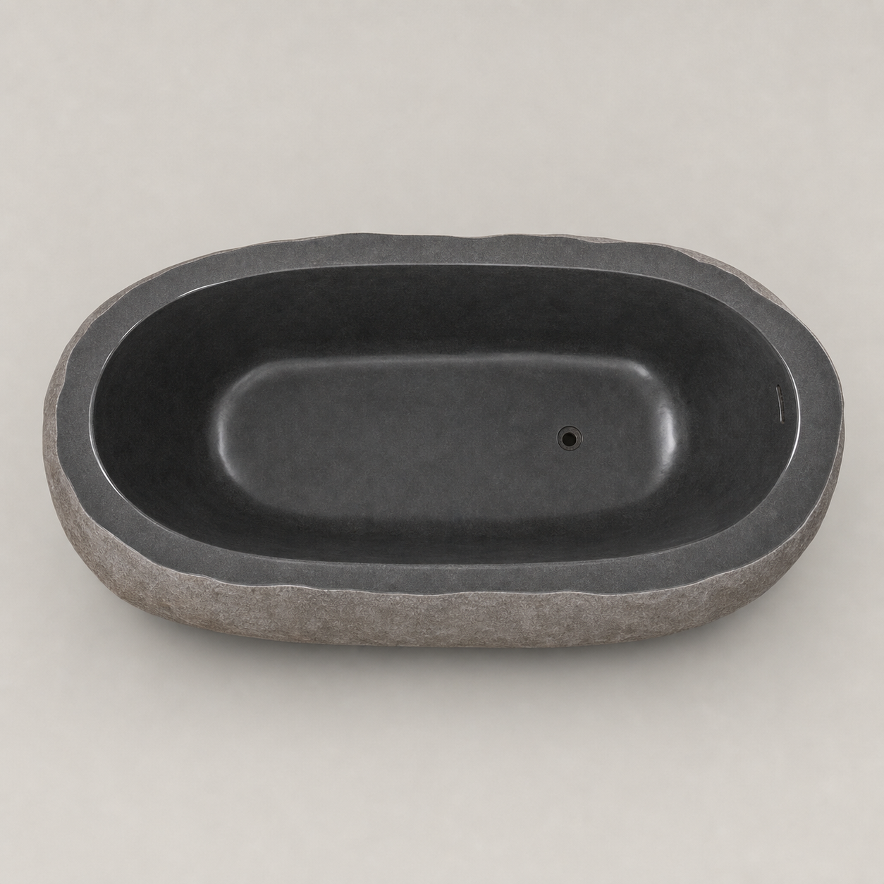 Cavira G654 Gray Granite bathtub, elevated studio view of the irregular rim, dark interior and offset drain
