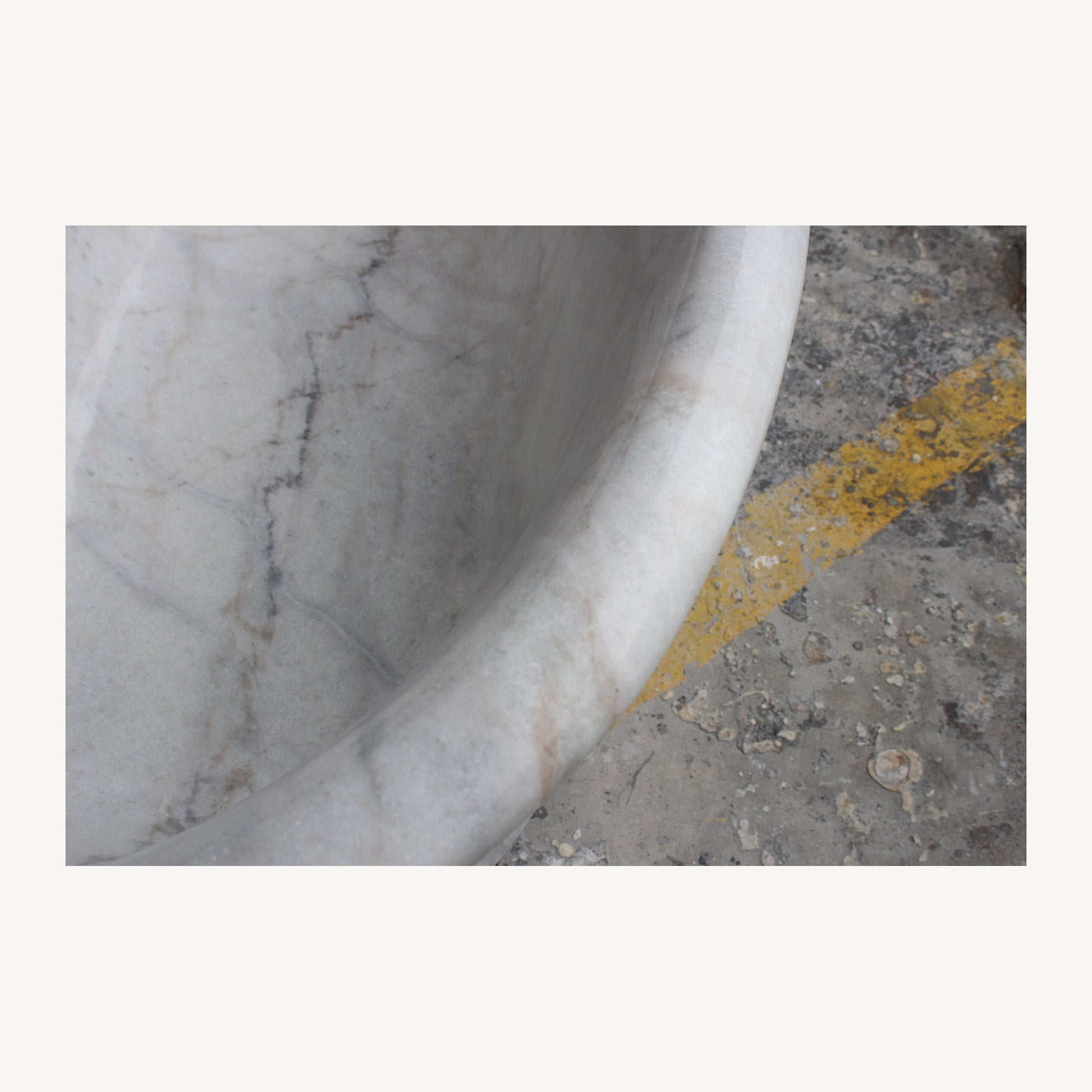 Elara bathtub thin rolled marble rim with natural gray and warm mineral veining detail
