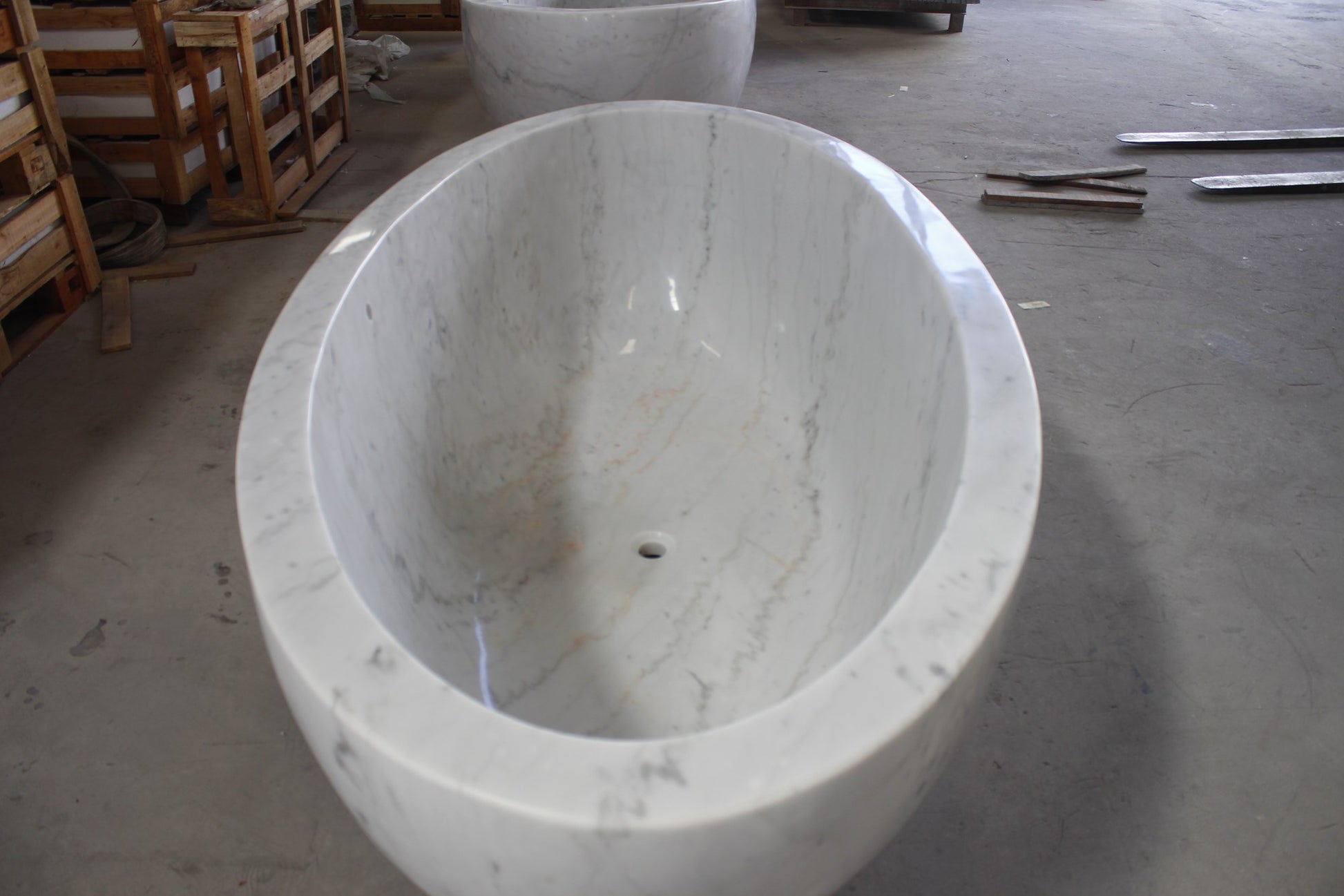 Actual Mira BT-031A deep oval marble bathtub, overhead view with centered drain