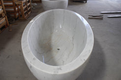 Actual Mira BT-031A deep oval marble bathtub, overhead view with centered drain