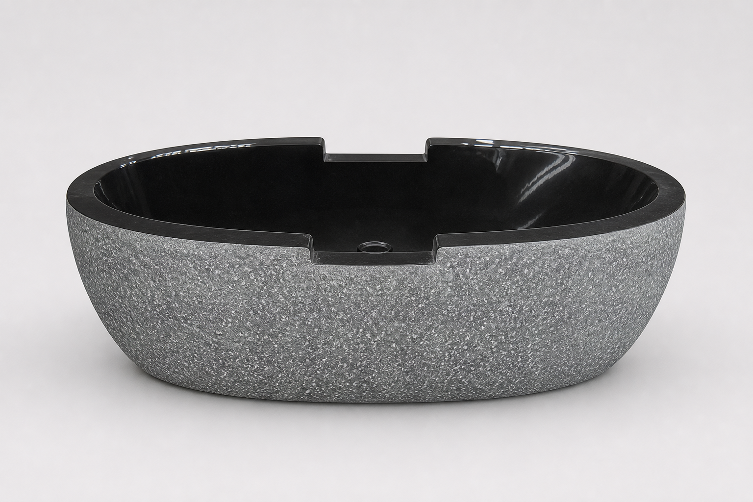 Noctira Absolute Black Granite bathtub, textured exterior side-profile studio visualization