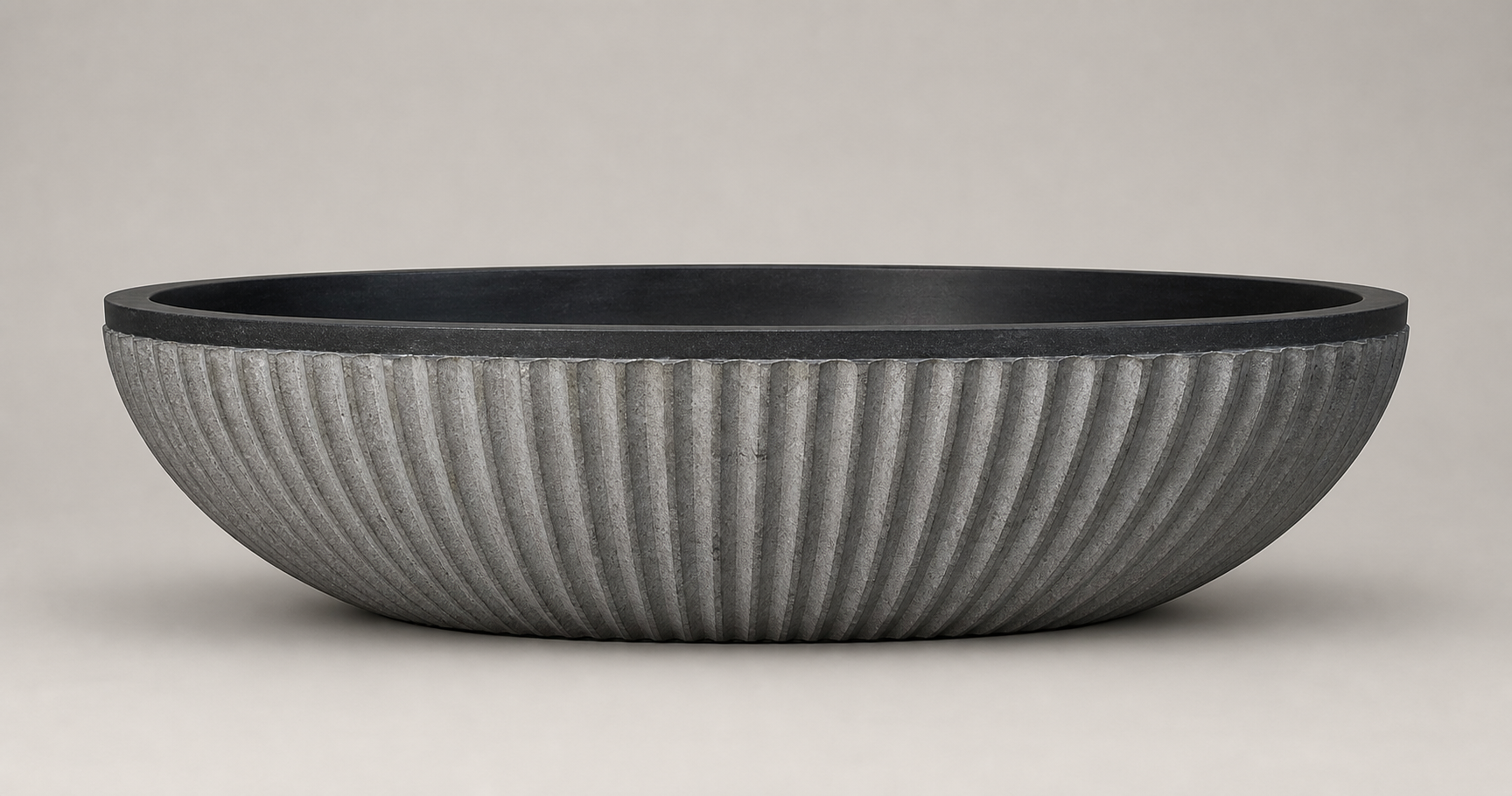 Rivelle Natural Black Granite bathtub with vertical ribbed exterior, side profile
