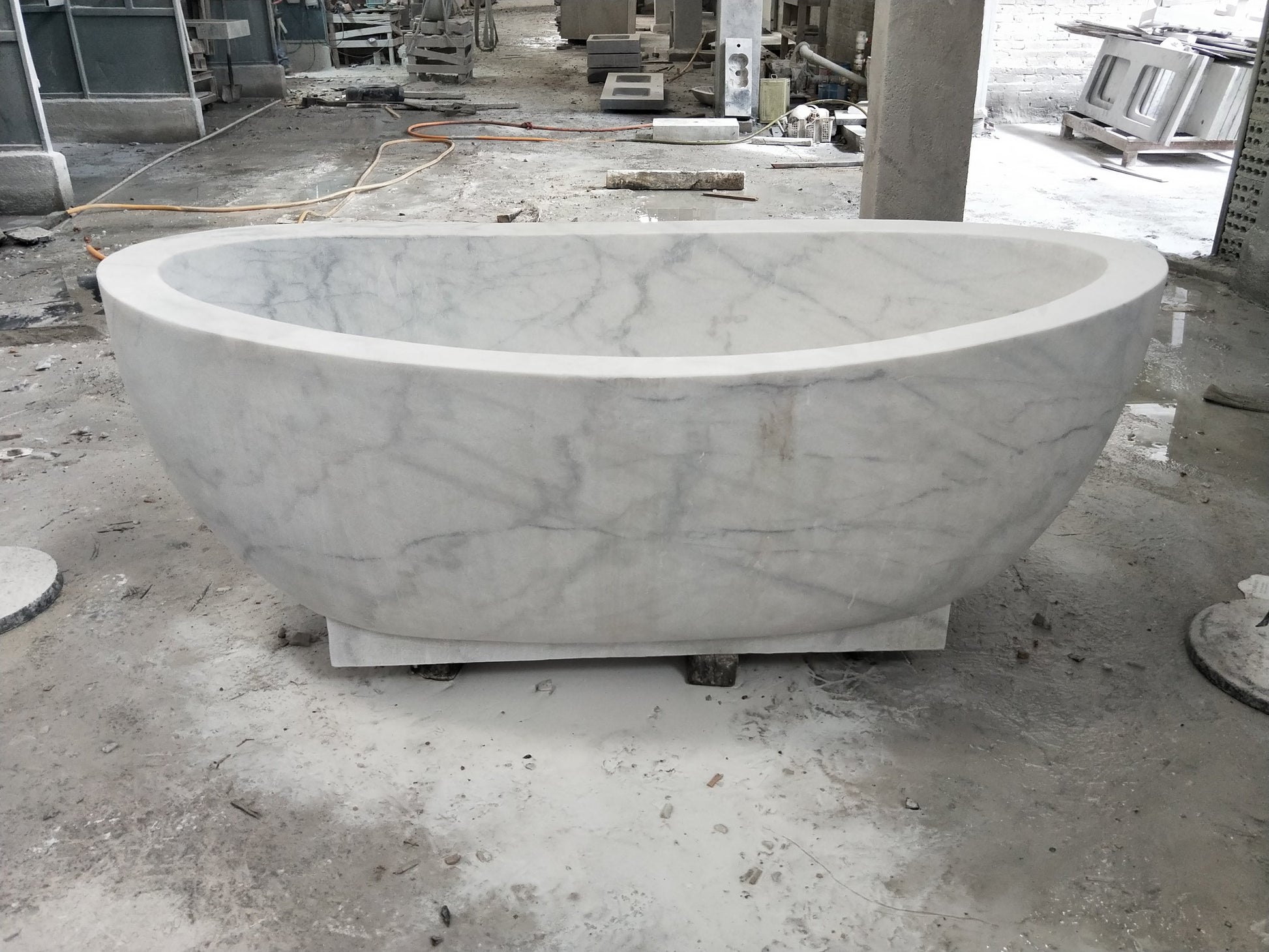 Actual Aurelia BT-038A Ivory Cloud Marble pedestal bathtub at the stone workshop, front view