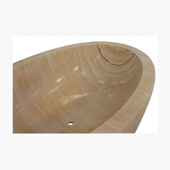 Lysara Natural Sandstone bathtub material reference showing warm mineral banding and layered stone pattern