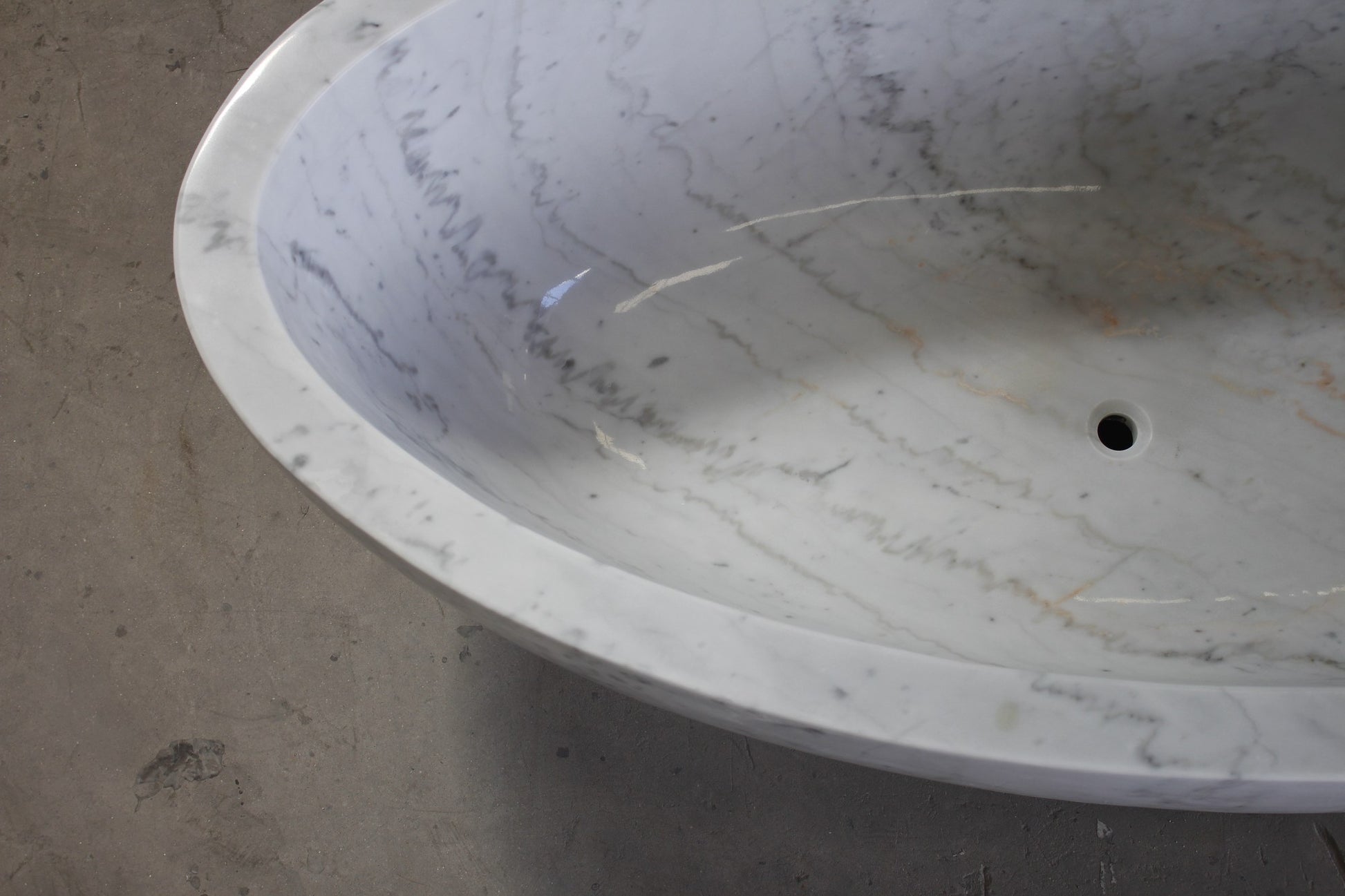 Mira Ivory Cloud Marble bathtub polished interior, natural veining, and drain detail