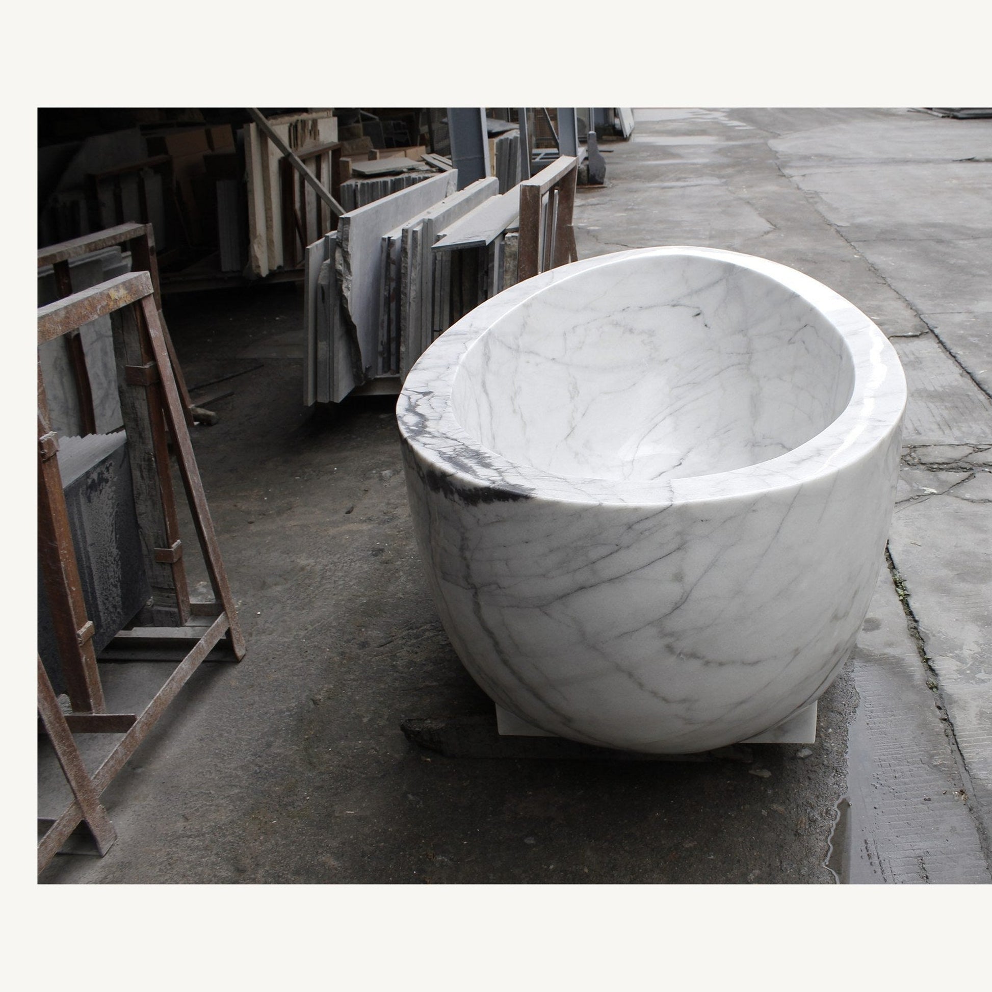 Celeste Ivory Cloud Marble soaking bathtub, real end view and sculptural bowl profile
