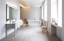 Elara Ivory Cloud Marble soaking bathtub in a bright bathroom styled visualization