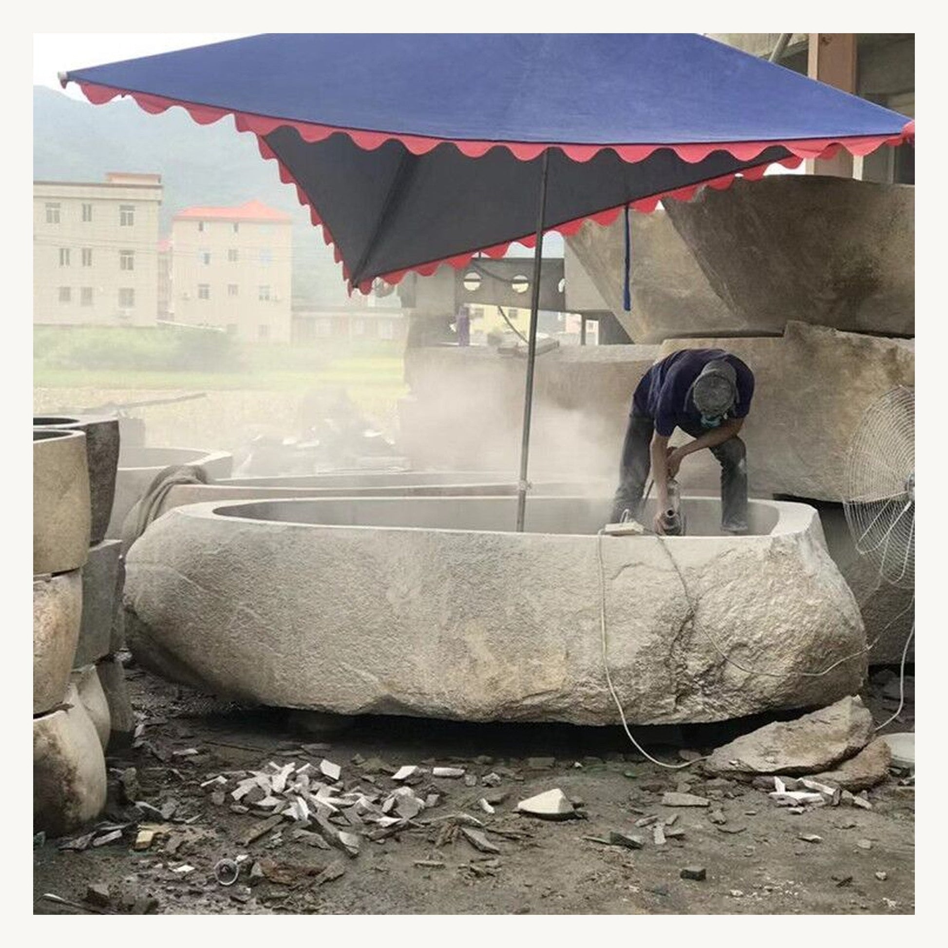 OIXDESIGN natural stone bathtub production process showing Filetto Cobble Stone granite carving and hand finishing