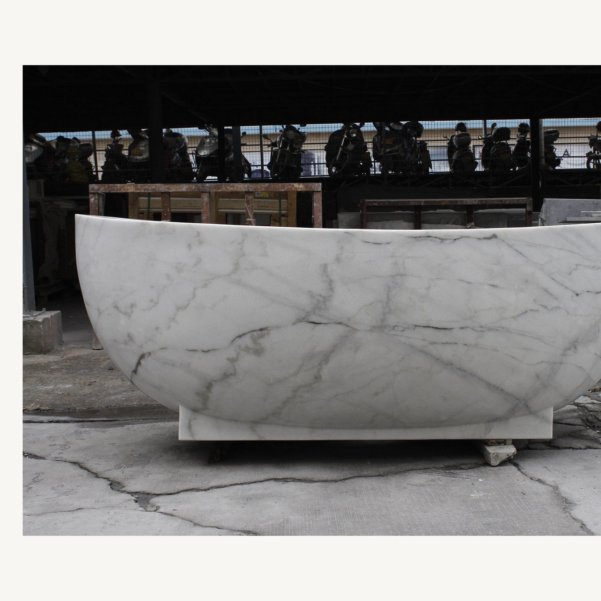 Celeste Ivory Cloud Marble soaking bathtub, real long-side profile and pedestal base
