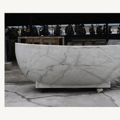 Celeste Ivory Cloud Marble soaking bathtub, real long-side profile and pedestal base