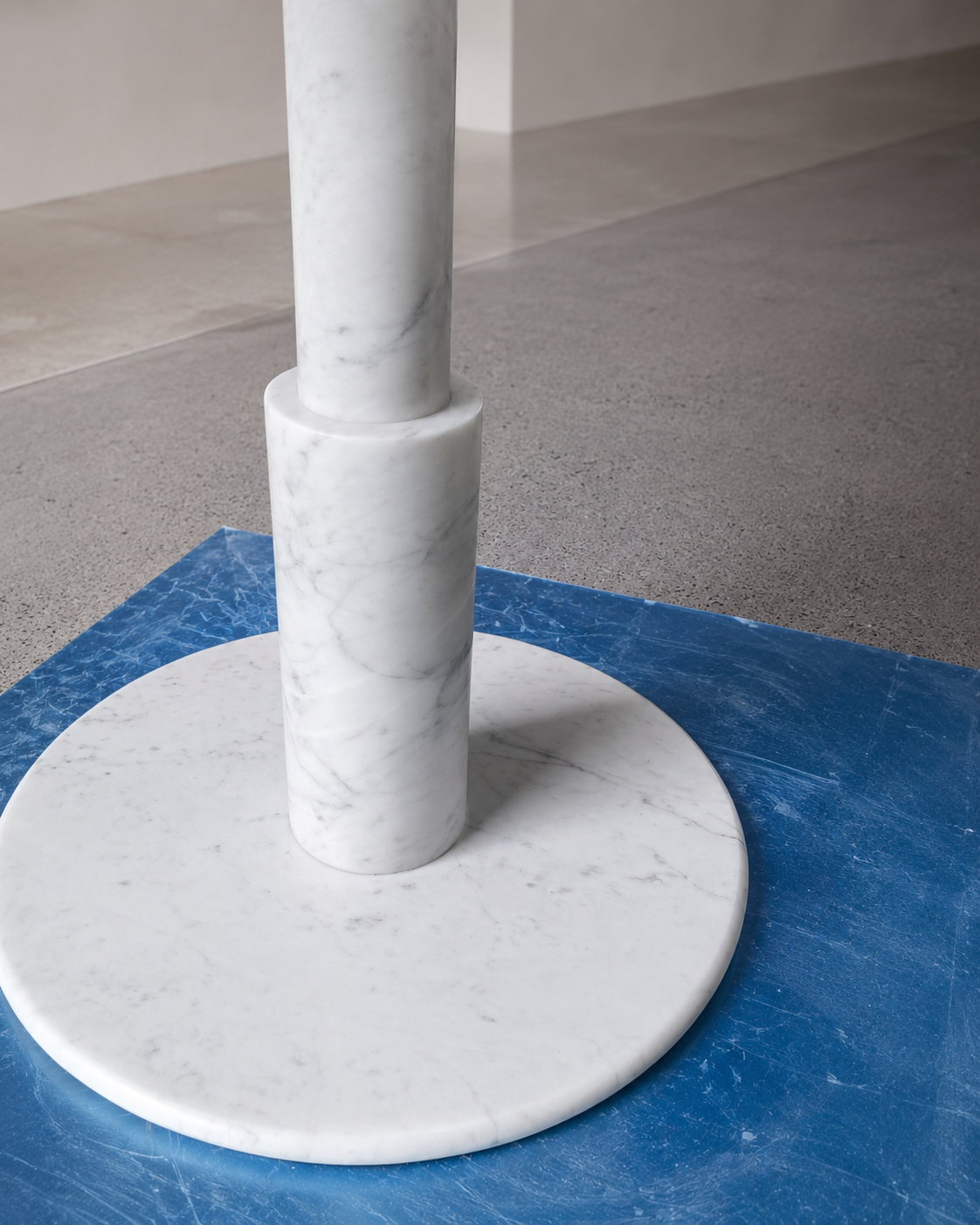 RoundTwin Elite Carrara marble dining table low angle view showing round pedestal structure